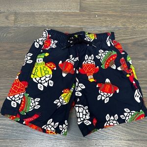 Boys Vilebrequin bathing suit with little turtles, wearing sweaters and hats.